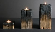 three wooden candles sitting next to each other