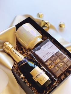 a bottle of wine and some chocolates in a box