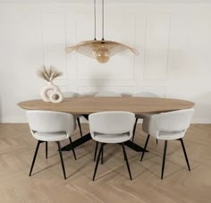 a dining room table with four chairs around it