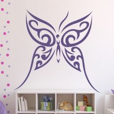 a butterfly wall decal in a child's room with pink polka dots on the walls