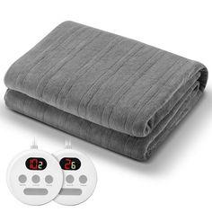 two electric heated blankets with thermometers on each one and an alarm clock