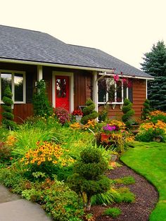 a house with lots of flowers in front of it