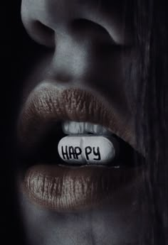 a woman's mouth with a pill in it that says happy on the side