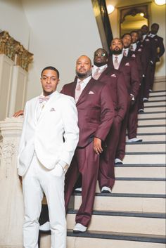 a group of men in suits standing on stairs