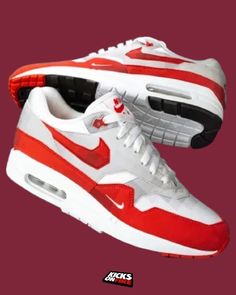 a pair of red and white nike shoes