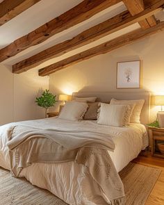 a large bed sitting under two lamps in a bedroom