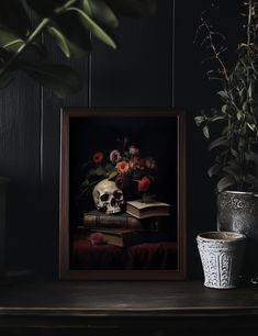 a skull and flowers on a table next to a potted plant in a dark room