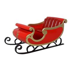 a red toy sleigh with gold trimmings