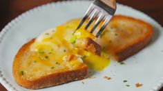 a piece of bread with cheese on it and a fork stuck in the top half