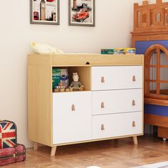 a child's room with a crib, dresser and toy cars on the floor