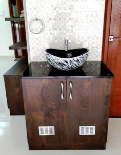 a bathroom sink sitting on top of a wooden cabinet