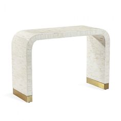 a white marble and gold - plated console table with an arch shaped like a rectangle