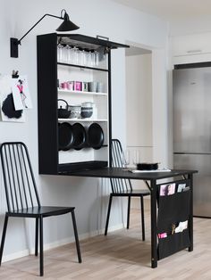 a black table and two chairs in a room