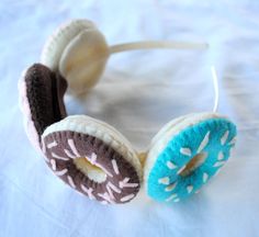 a pair of headphones made out of donuts on a white tablecloth with blue and brown sprinkles