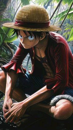 a man in a straw hat sitting on the ground with his hands under his knees