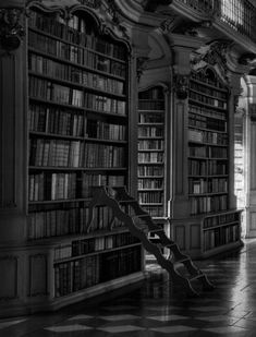 an empty library with many bookshelves filled with lots of books and a bench