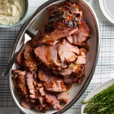 sliced ham and asparagus on a plate with mashed potatoes