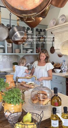 a woman and her daughter are in the kitchen preparing some food for their family to eat