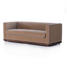 a brown couch sitting on top of a white floor