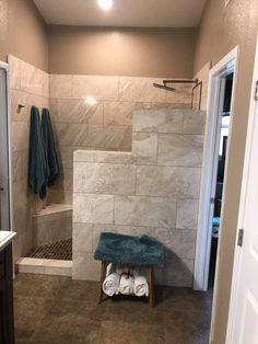 a bathroom with tiled walls and flooring next to a walk - in shower area