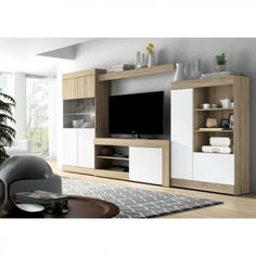 a living room with white and wood furniture in the center, including a large screen tv