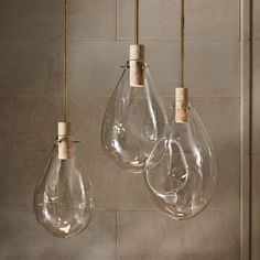 three light bulbs hanging from a wall