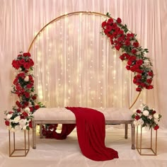 a wedding arch decorated with red and white flowers