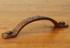 a wooden table with a metal handle on it