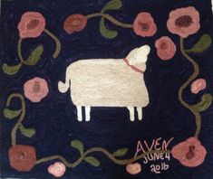 an embroidered sheep with flowers and vines on it's side, in front of a blue background