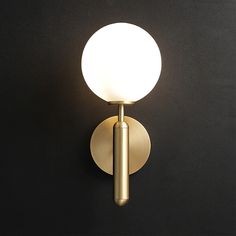 a light that is on the side of a wall mounted fixture with a white ball