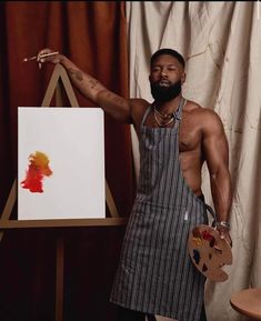 a man in an apron holding a paintbrush and palette