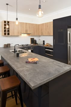 a kitchen with an island counter and stools