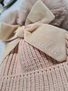 a hat with a bow and name on it