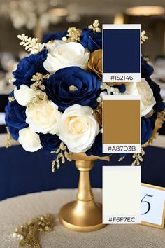 a blue and white wedding bouquet with gold accents on a round table in front of the color swatches