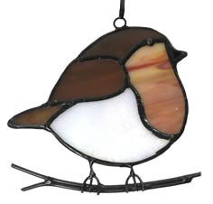 a stained glass bird sitting on top of a branch