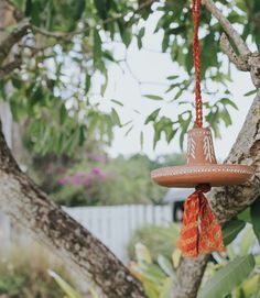 an orange and white decoration hanging from a tree