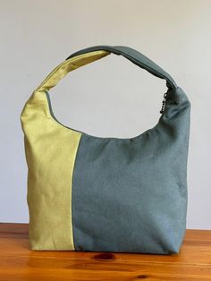 Check out our new color block lunch bag!! With 1/3 green and 2/3 army green, the asymmetrical color block design gives it a modern look. Inside is lined with yellow flower 100%  cotton fabric.  The Inusl-Brite (insulation material) in the middle and the zipper closure help keep the food fresh until lunch time. It is a great substitute for paper lunch bags or a small purse for everyday use. Carrying a lunch bag to work can be practical, fashionable and healthy for the environment, what could be better than that? :) It is a great substitute of paper bag, get one for family, friends, teacher or yourself ! Our lunch bag is beautifully handmade with attentions to details. You will just love it....It is upright and roomy to hold your food with a handle that opens up to make it easier to pack.  W Green Canvas School Bag With Removable Pouch, Large Capacity Green Hobo Bag For School, Green Color Block Bags For Everyday, Green Large Capacity Hobo Bag For School, Green Shoulder Canvas Bag With Removable Pouch, Green Canvas Bag With Removable Pouch For Everyday, Green Tote Hobo Bag For School, Green Canvas Shoulder Bag With Removable Pouch, Green Rectangular Canvas Bag With Removable Pouch