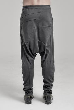 "DISTORTED ANTHRACITE DROPPED CROTCH TRACK PANTS WITH ELASTIC WAISTBAND __ELASTIC WAISTBAND WITH DRAWSTRING __J SHAPED LEGS __2 FRONT POCKETS __2 REAR BONDED POCKETS __ASYMMETRICAL HIDDEN FRONT CLOSURE model__ chest 103 (40.5\"), waist 77 (30.3\"), hips 96 (37.8\"), biceps 35 (13.8''), height 180 (5'11\"), kg 74 (163 lbs) model wears size S | color: anthracite with black matte tape fabric__ 100 cotton care__ delicate machine wash at 30 c wash inside out use cool iron do not tumble dry sizing__ s Futuristic Pants, Urban Clothing Men, Low Crotch Pants, Sporty Leggings, Winter Tights, Track Pants Mens, Tshirt Printing, Tshirt Printing Design, Mens Tights