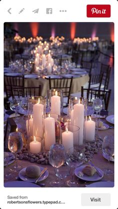 the table is set with many candles and place settings for dinner guests to enjoy their meal