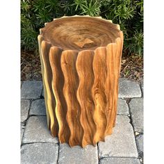 a wooden stump sitting on top of a stone walkway