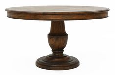 a round wooden table sitting on top of a white floor