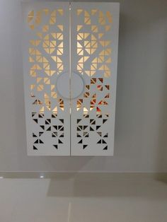 an open door with geometric designs on the outside and inside, in a white room