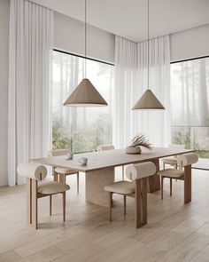 a dining room table and chairs in front of large windows