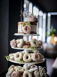 three tiered wedding cake with donuts and flowers