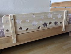 a wooden bed with stars painted on it