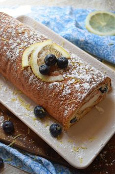 a pastry with lemon slices and blueberries on it