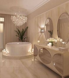 an elegant bathroom with chandelier, bathtub and candles