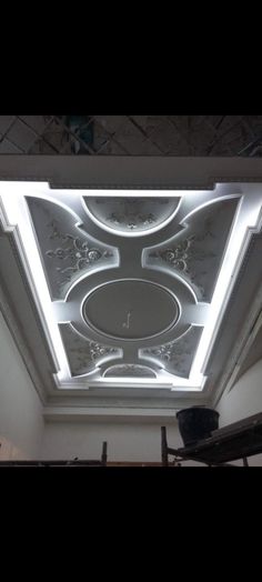 the ceiling in this room has been decorated with white and silver paint, while the lighting is