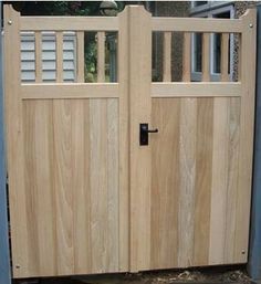 two wooden doors are open in front of a house