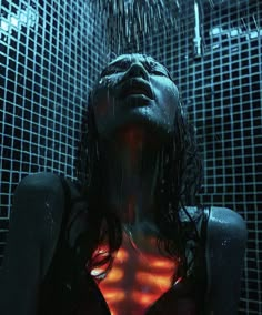 a woman is standing in the shower with her back to the camera and glowing under water